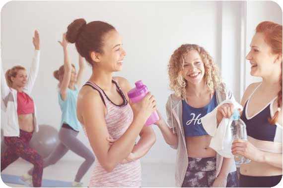 Three Women after a workout drinking water 