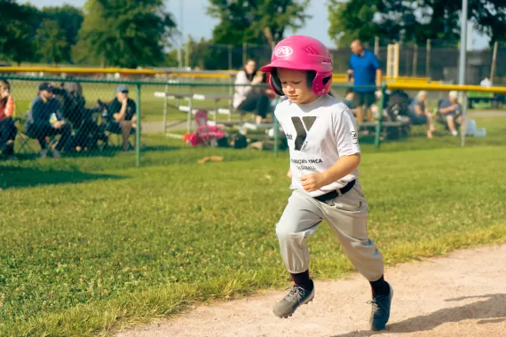 Little girl running bases in baseball
