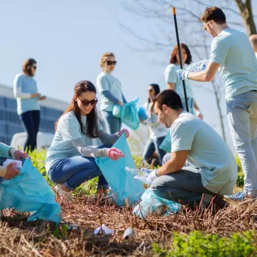 A group of people volunteering by picking up trash